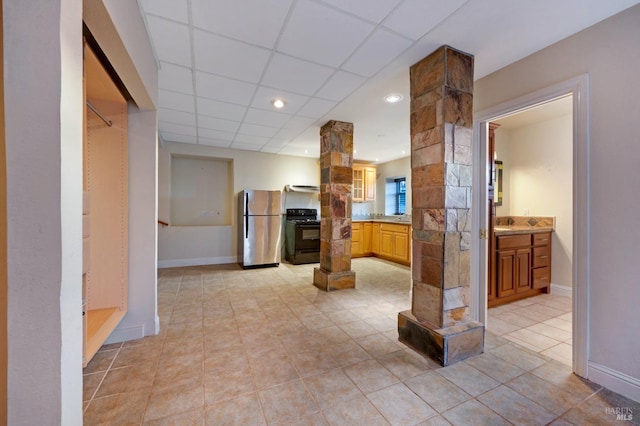 146 Shelina Vista Ln, Petaluma, CA 94952 - kitchen featuring baseboards, black range with electric cooktop, ornate columns, and freestanding refrigerator