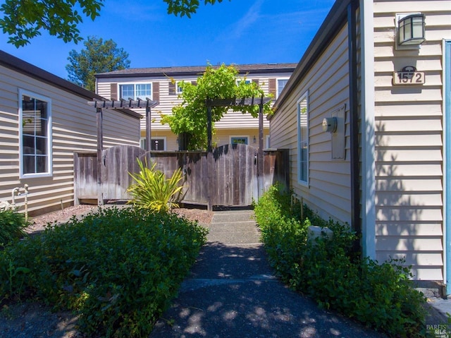 view of yard featuring a pergola and fence