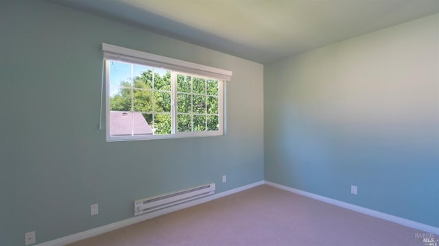 empty room with a baseboard radiator, carpet flooring, and baseboards