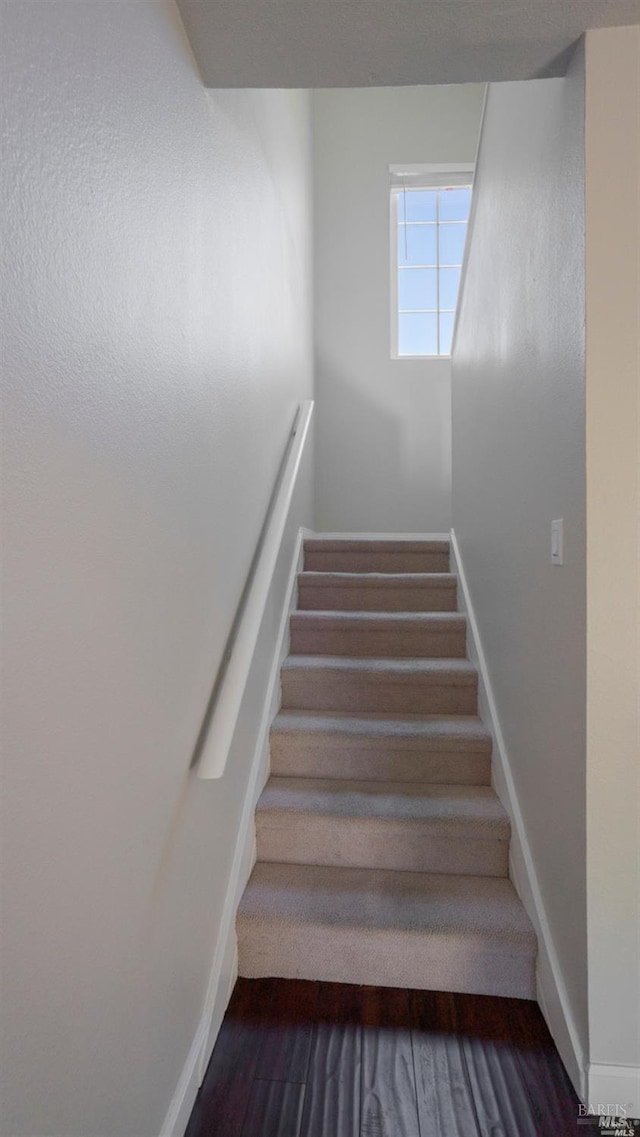 stairs with baseboards and wood finished floors