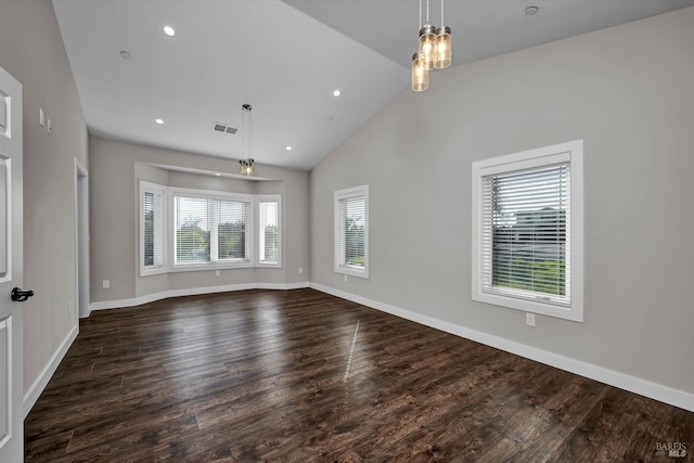 unfurnished living room featuring dark wood-style floors, visible vents, and baseboards