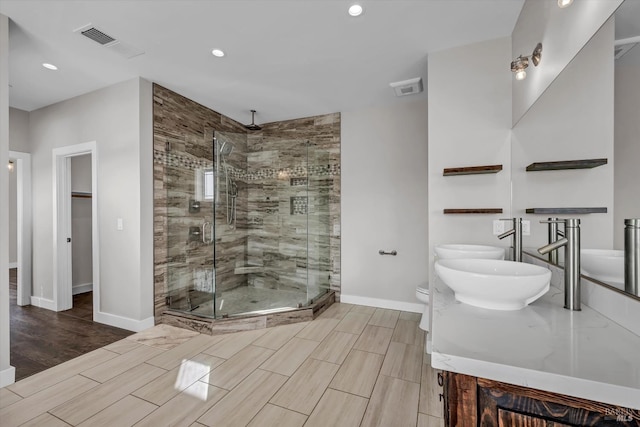 full bath with wood tiled floor, visible vents, a stall shower, and baseboards