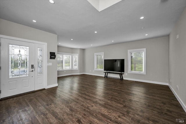 foyer with recessed lighting, wood finished floors, and baseboards