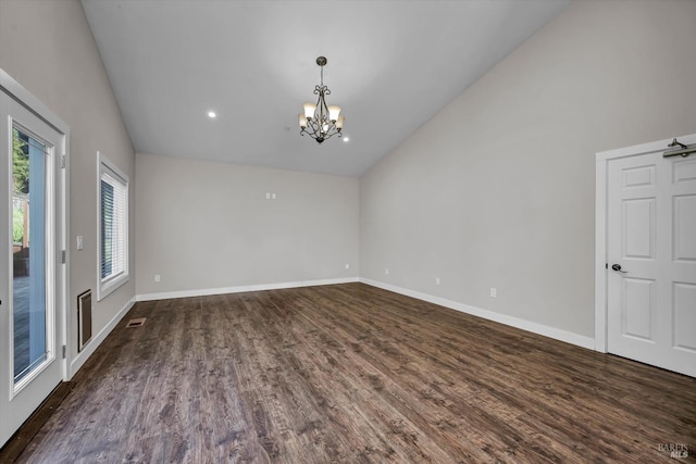 unfurnished room featuring an inviting chandelier, visible vents, dark wood-style floors, and baseboards