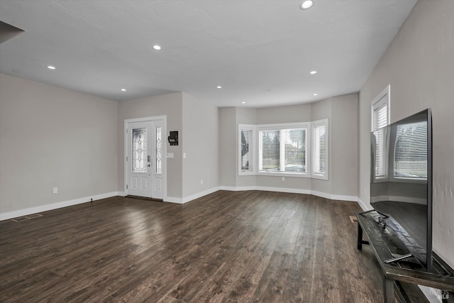 unfurnished living room with visible vents, recessed lighting, dark wood-style floors, and baseboards