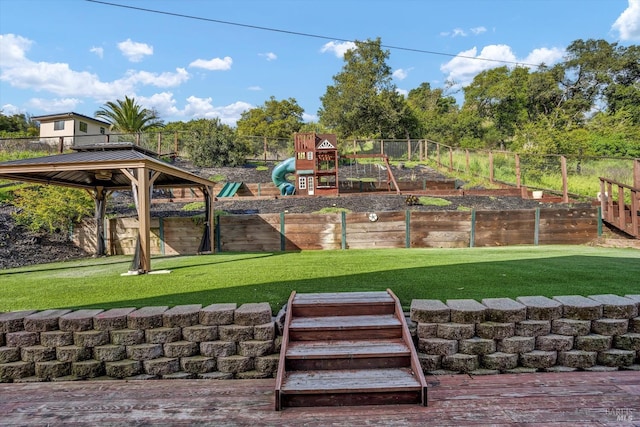 exterior space featuring a lawn, fence, and a vegetable garden