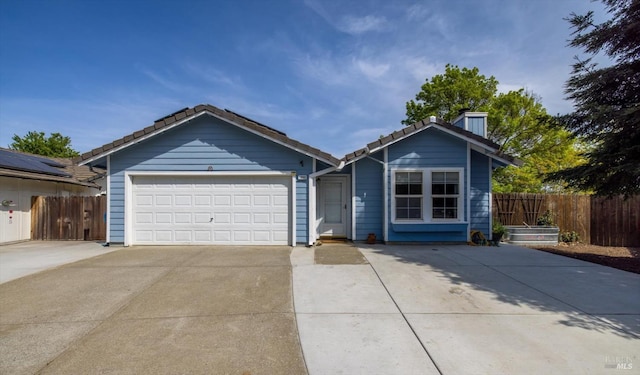 ranch-style home with driveway, a garage, fence, and a tile roof
