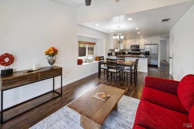 living room with dark wood-type flooring, visible vents, recessed lighting, a chandelier, and baseboards