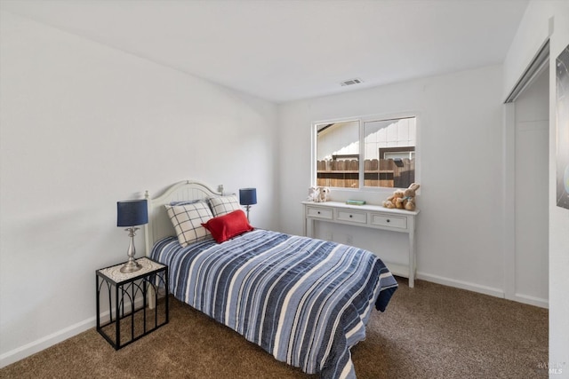 carpeted bedroom with baseboards and visible vents