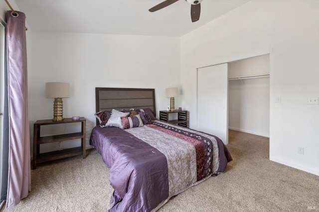 bedroom with a closet, baseboards, a spacious closet, carpet flooring, and a ceiling fan
