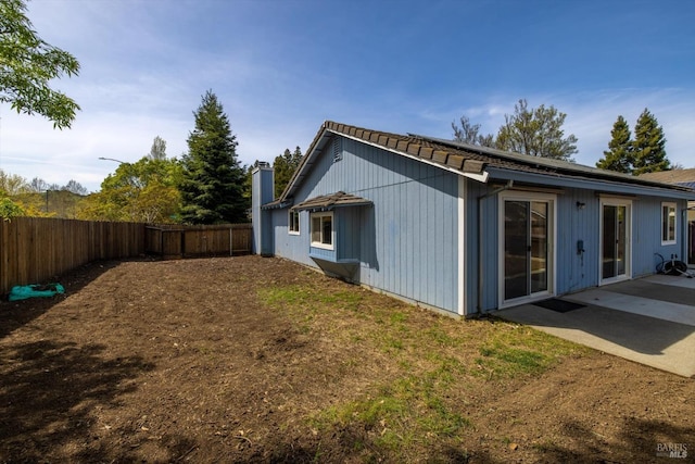 back of house featuring a patio and a fenced backyard