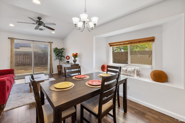 dining space featuring ceiling fan with notable chandelier, recessed lighting, dark wood-style flooring, lofted ceiling, and baseboards
