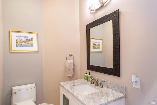 half bath with vanity and toilet