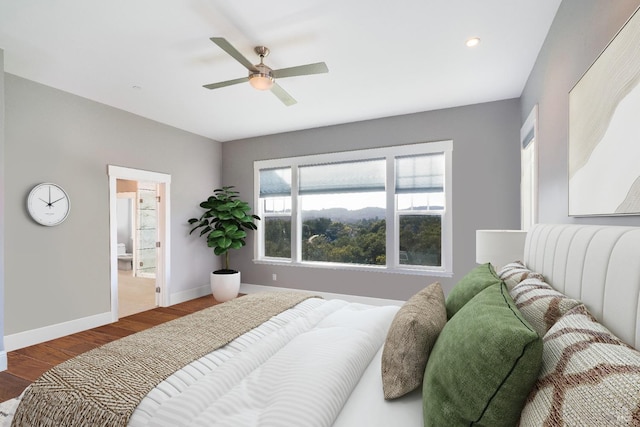 bedroom with baseboards, recessed lighting, ceiling fan, and wood finished floors