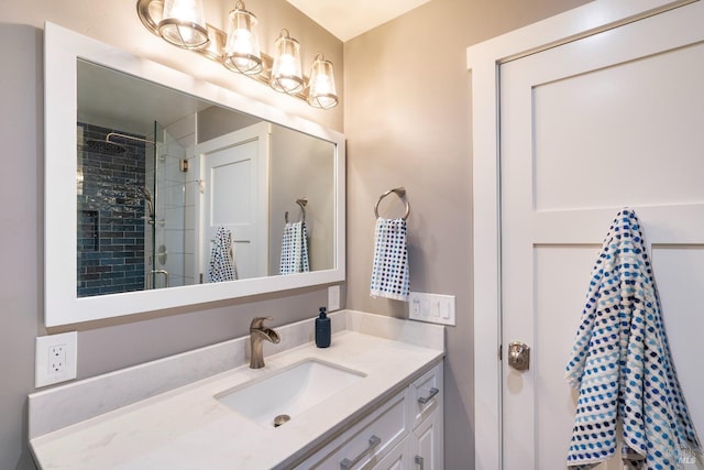 bathroom featuring vanity, a stall shower, and a chandelier