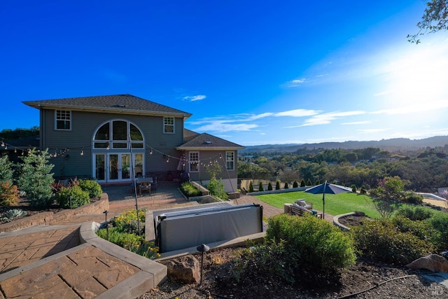 back of property featuring a mountain view and french doors