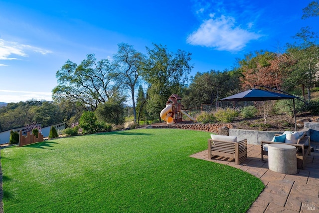 view of yard with outdoor lounge area, a playground, and a patio area