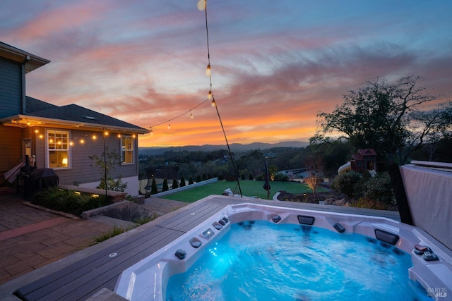 view of pool with a yard, grilling area, and a covered hot tub