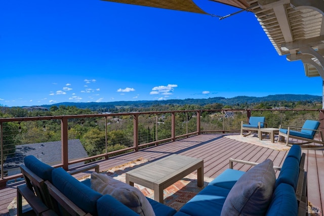 wooden deck with a mountain view and outdoor lounge area