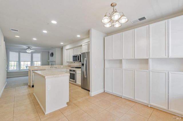 kitchen with light tile patterned floors, visible vents, light countertops, and appliances with stainless steel finishes