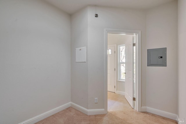 interior space with electric panel, light colored carpet, and baseboards