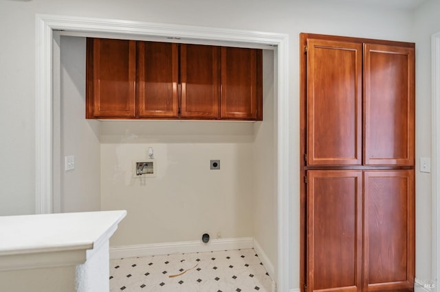 laundry room featuring hookup for a washing machine, light floors, hookup for an electric dryer, baseboards, and cabinet space