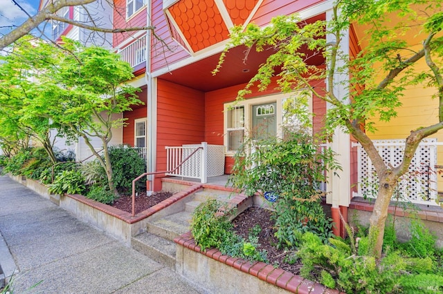 property entrance featuring a balcony and covered porch
