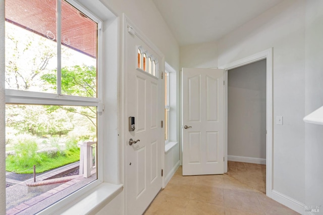 entryway featuring light tile patterned floors and baseboards