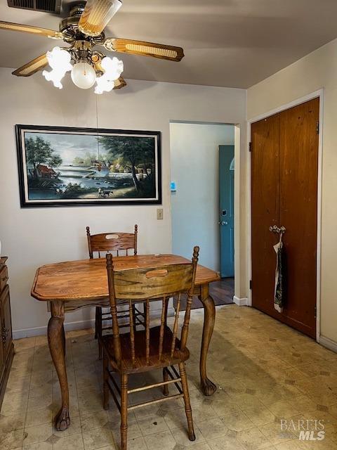 dining area featuring baseboards and a ceiling fan
