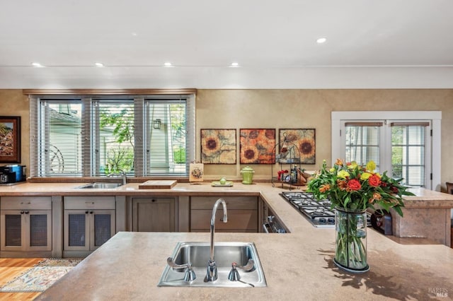 kitchen featuring recessed lighting, light countertops, and a sink