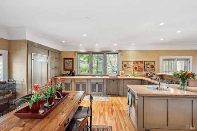 kitchen with paneled built in refrigerator, recessed lighting, light wood-type flooring, and a sink