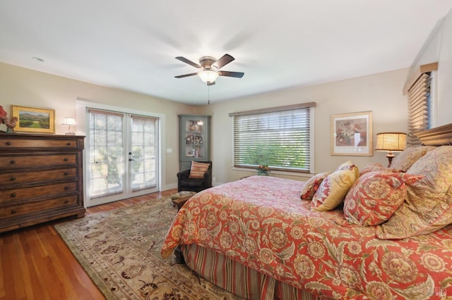 bedroom featuring multiple windows, french doors, wood finished floors, and access to exterior