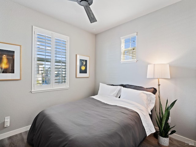 bedroom with baseboards, wood finished floors, and ceiling fan