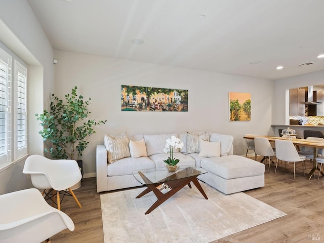 living area featuring visible vents, recessed lighting, and wood finished floors