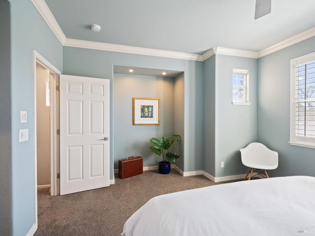 carpeted bedroom featuring crown molding and baseboards