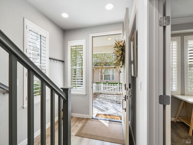 entrance foyer with baseboards, recessed lighting, stairs, and light wood finished floors