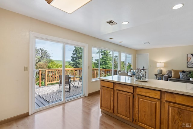 263 Carlisle Way, Benicia, CA 94510 - kitchen with brown cabinetry, light countertops, light wood-style flooring, baseboards, and open floor plan