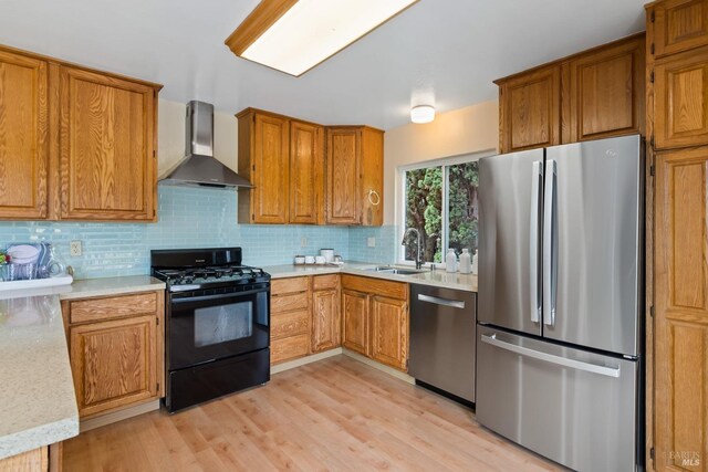 263 Carlisle Way, Benicia, CA 94510 - kitchen with stainless steel appliances, wall chimney range hood, a sink, brown cabinetry, and light countertops