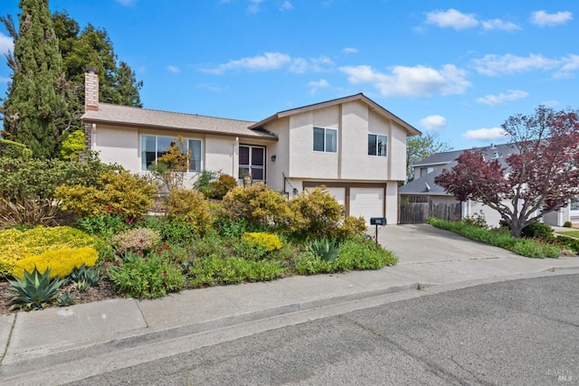 263 Carlisle Way, Benicia, CA 94510 - view of front facade featuring concrete driveway, stucco siding, fence, an attached garage, and a chimney