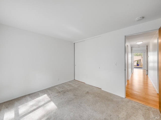 unfurnished room featuring light colored carpet