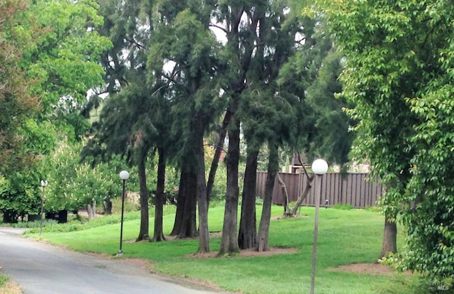 exterior space with fence and a lawn
