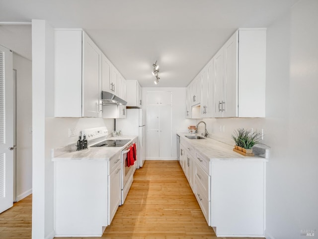 kitchen with light wood-type flooring, light countertops, under cabinet range hood, white electric range, and a sink
