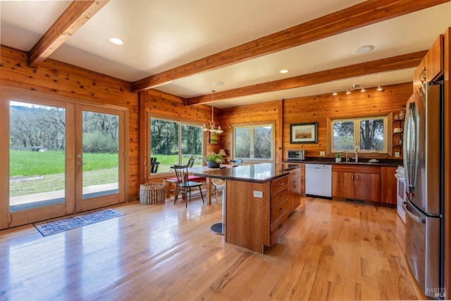 13679 Powerhouse Rd, Potter Valley, CA 95469 - kitchen with freestanding refrigerator, dark countertops, light wood-style floors, brown cabinets, and dishwasher