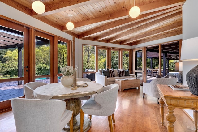 sunroom / solarium with french doors, a wealth of natural light, and beamed ceiling