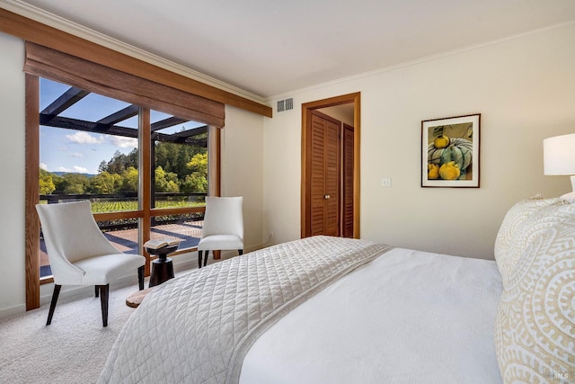 bedroom featuring carpet flooring, ornamental molding, and visible vents