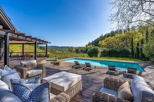 outdoor pool featuring a pergola, a deck, and an outdoor hangout area