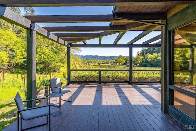 deck featuring a mountain view and a pergola