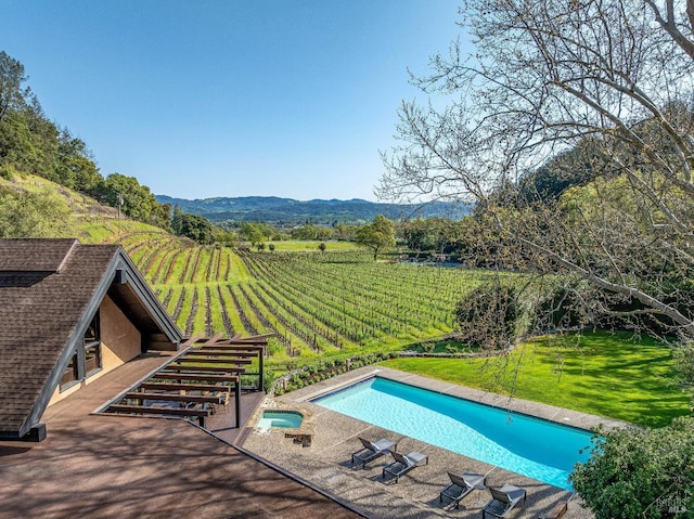 deck with a rural view and a mountain view