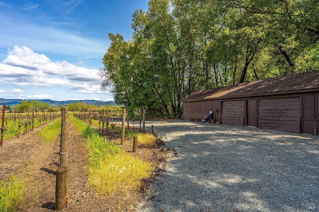 view of road featuring driveway and a rural view