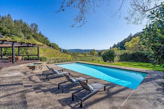 view of pool featuring a fenced in pool, a patio area, a mountain view, and a lawn